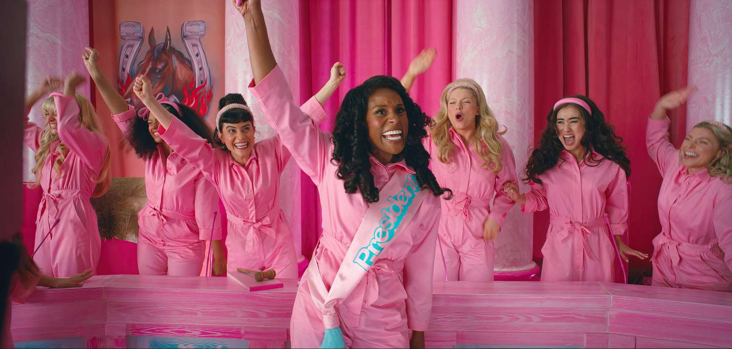Issa Rae elected as President Barbie, flanked by Barbie representatives of the "Pinkhouse". Everyone wears pink jumpsuits and cheers.